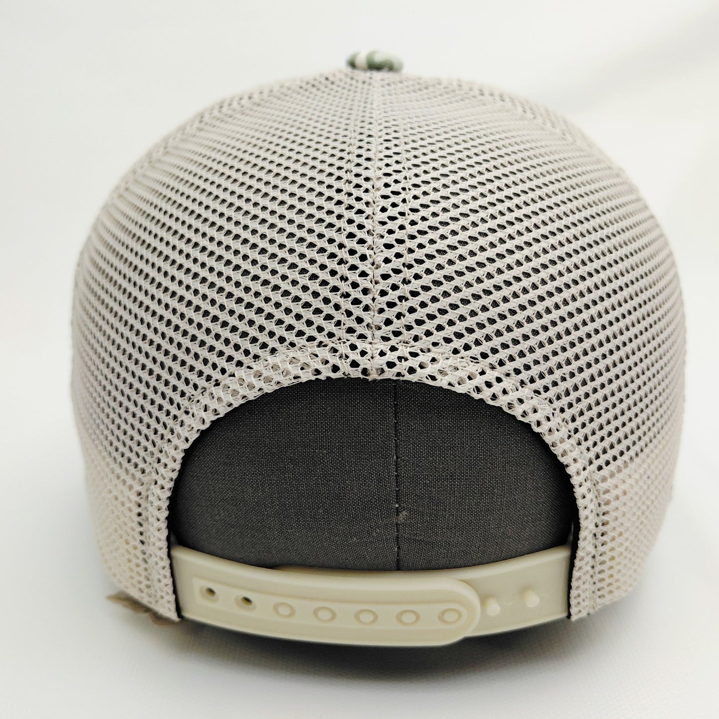 Cream mesh back and adjustable snap closure of Black Pond light camouflage trucker hat