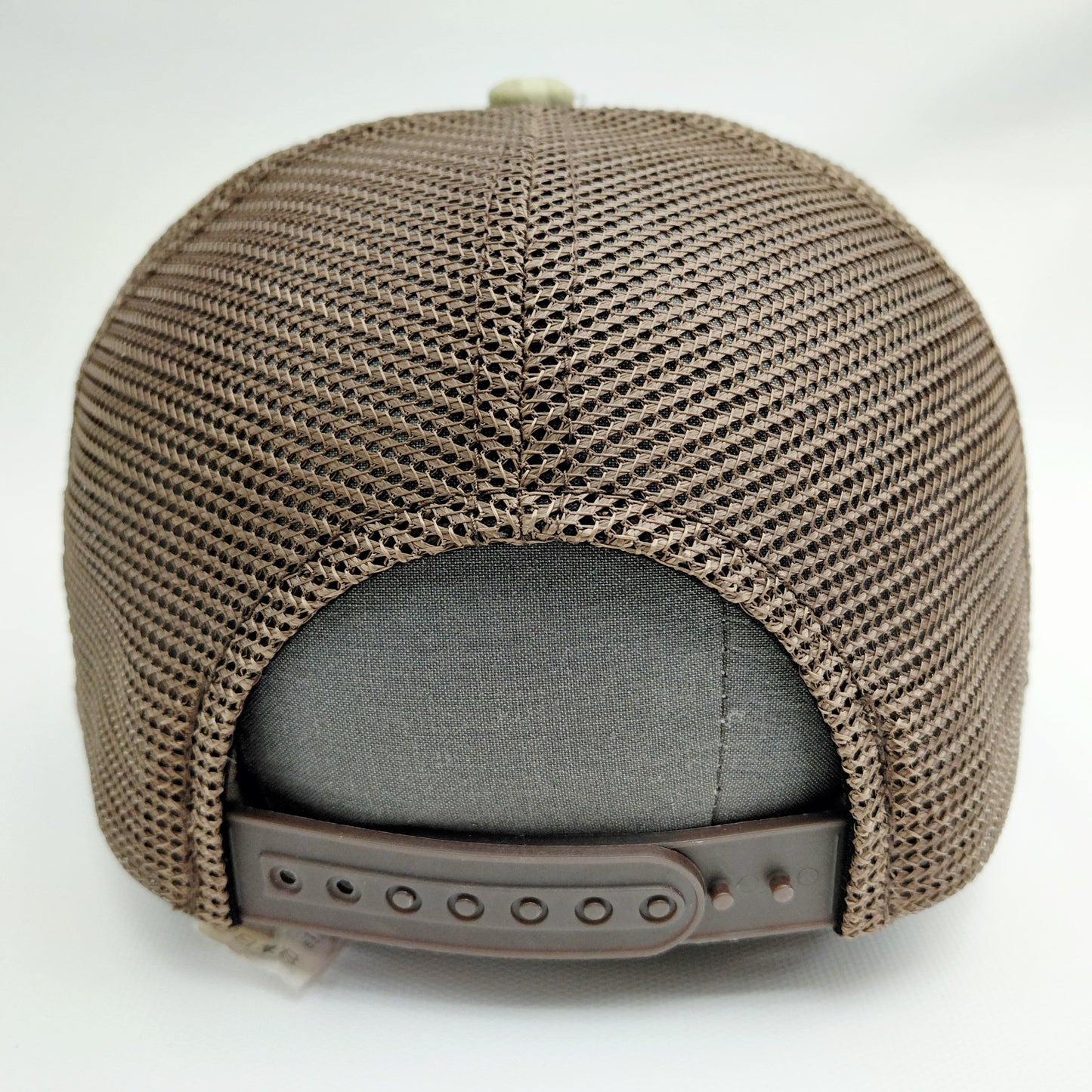 Brown mesh back and adjustable snap closure of Black Pond camouflage trucker hat