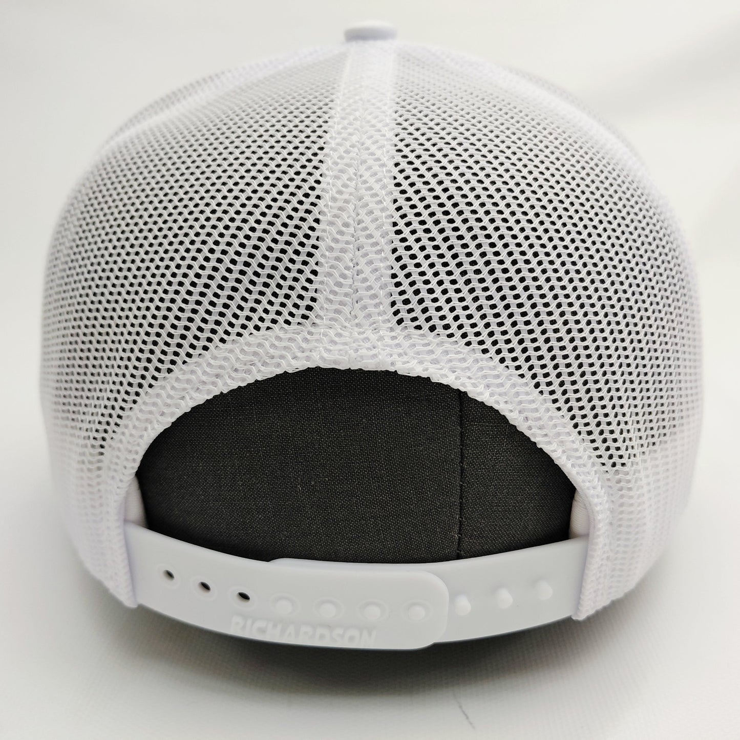 White mesh back and adjustable snap closure of all-white Black Pond Richardson 112 hat