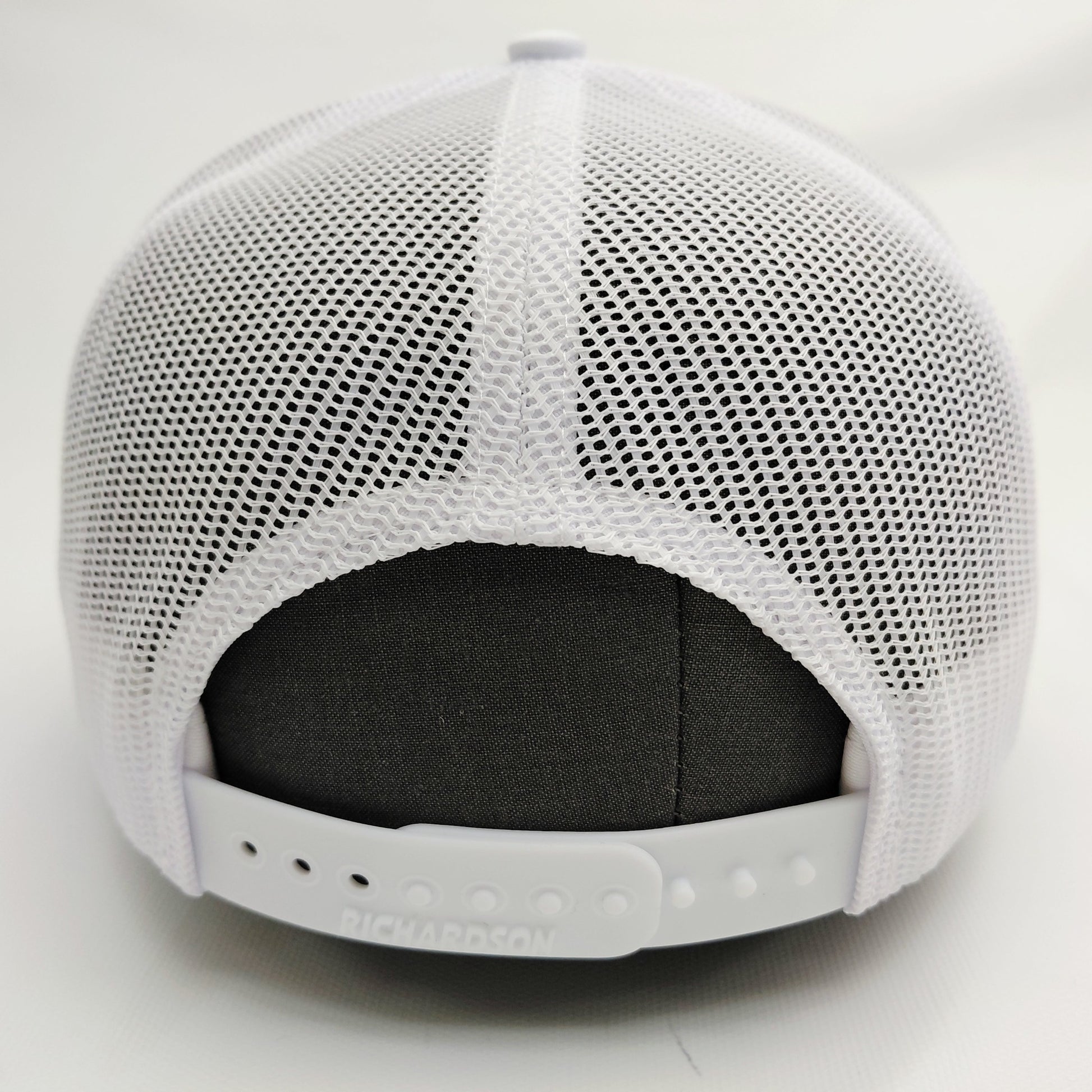 White mesh back and adjustable snap closure of all-white Black Pond Richardson 112 hat