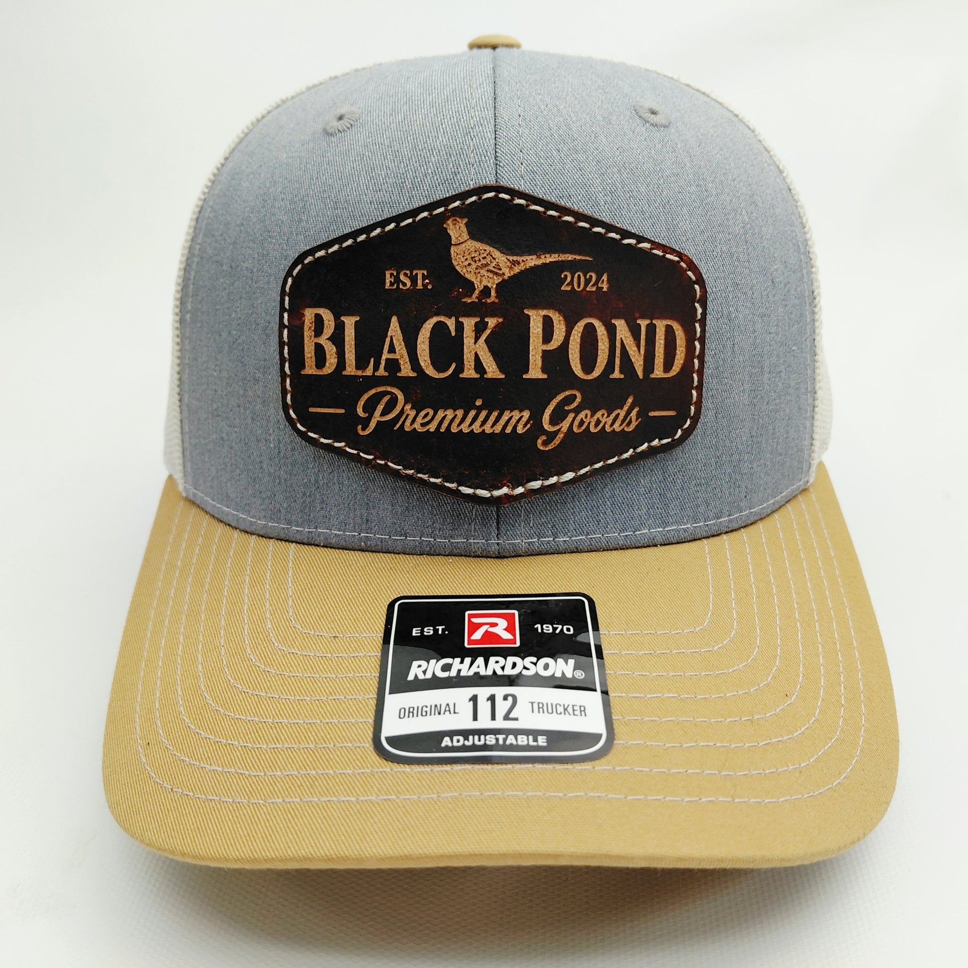 Front view of Black Pond pheasant leather patch Richardson 112 curved bill hat in gray tan and white