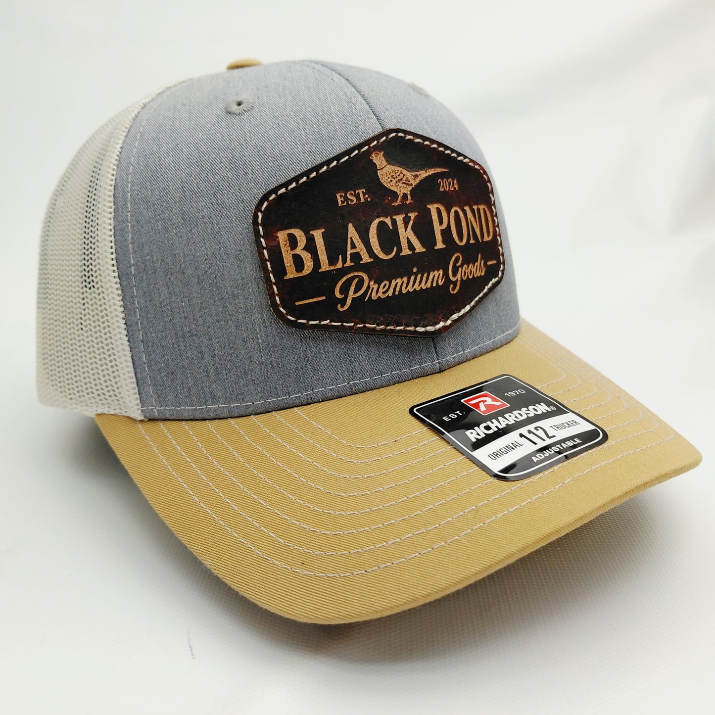 Right angled view of Black Pond pheasant leather patch Richardson 112 trucker hat