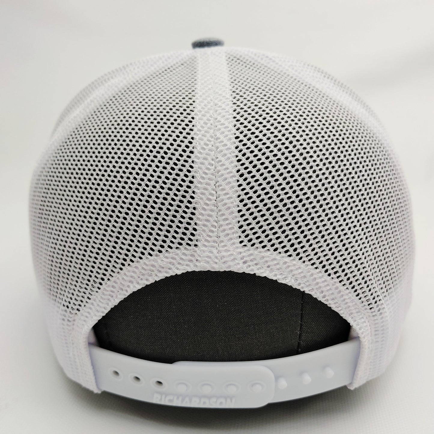 White mesh back and adjustable snap closure of Black Pond Richardson 112 hat
