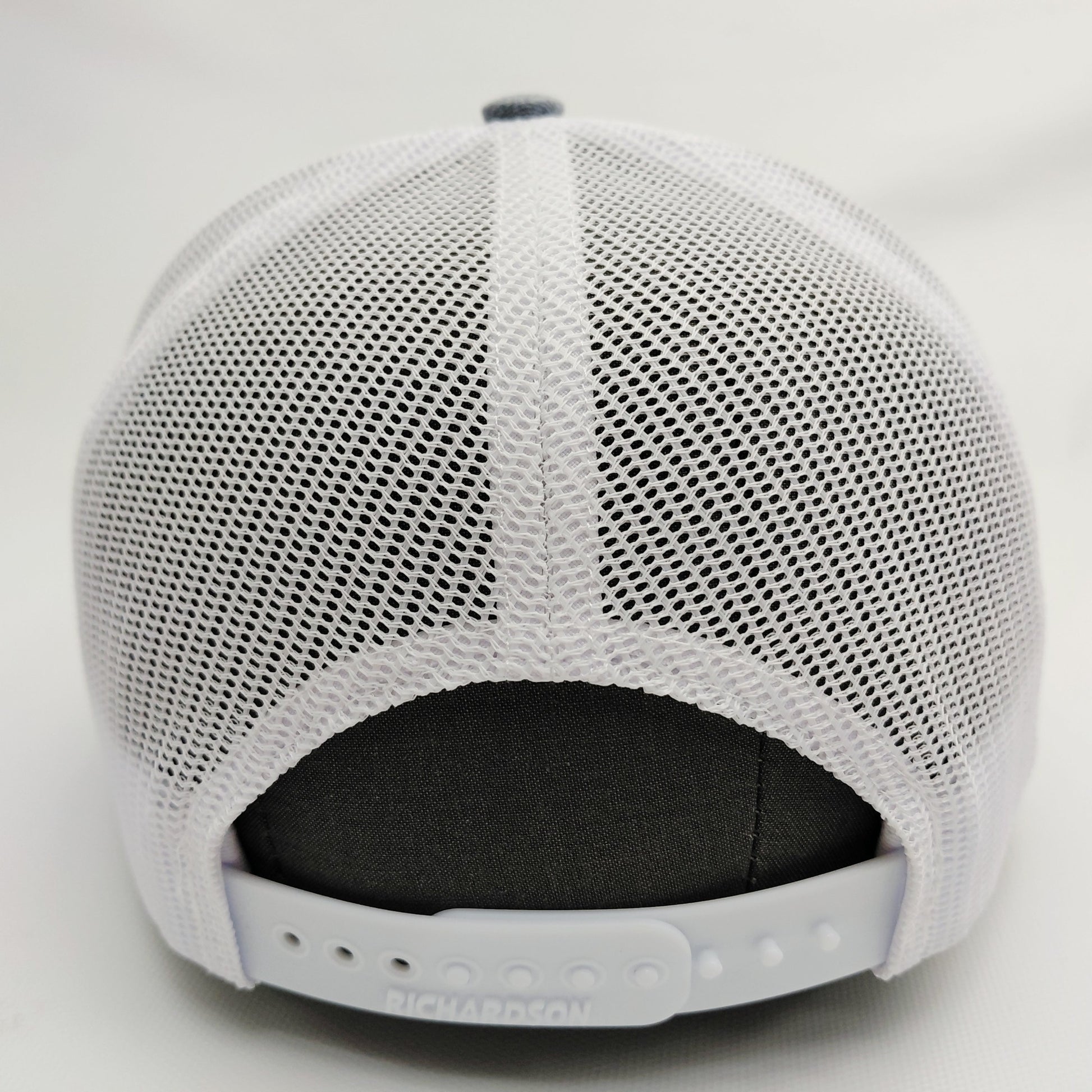 White mesh back and adjustable snap closure of Black Pond Richardson 112 hat