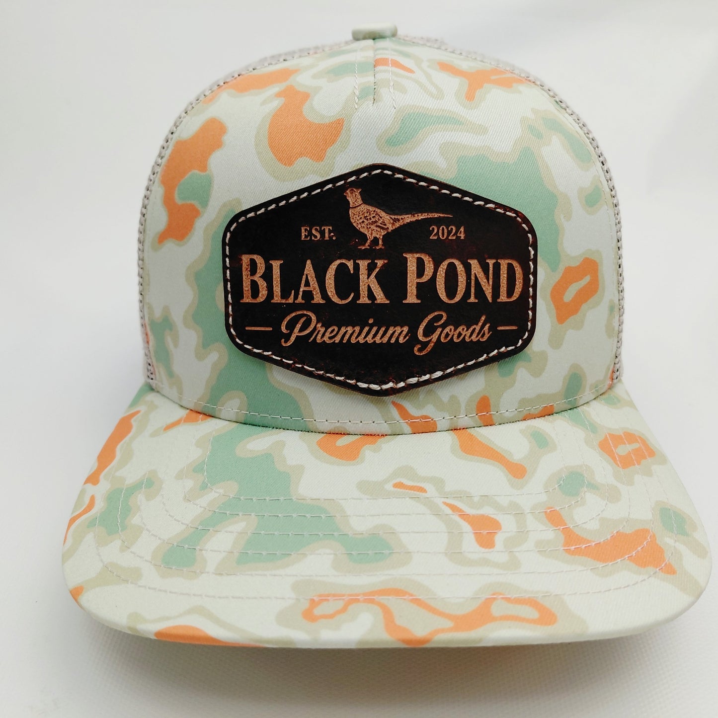 Front view of Black Pond pheasant leather patch Richardson 112 hat in mint and orange camouflage