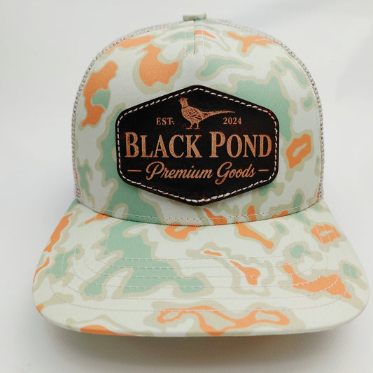 Front view of Black Pond pheasant leather patch Richardson 112 hat in mint and orange camouflage