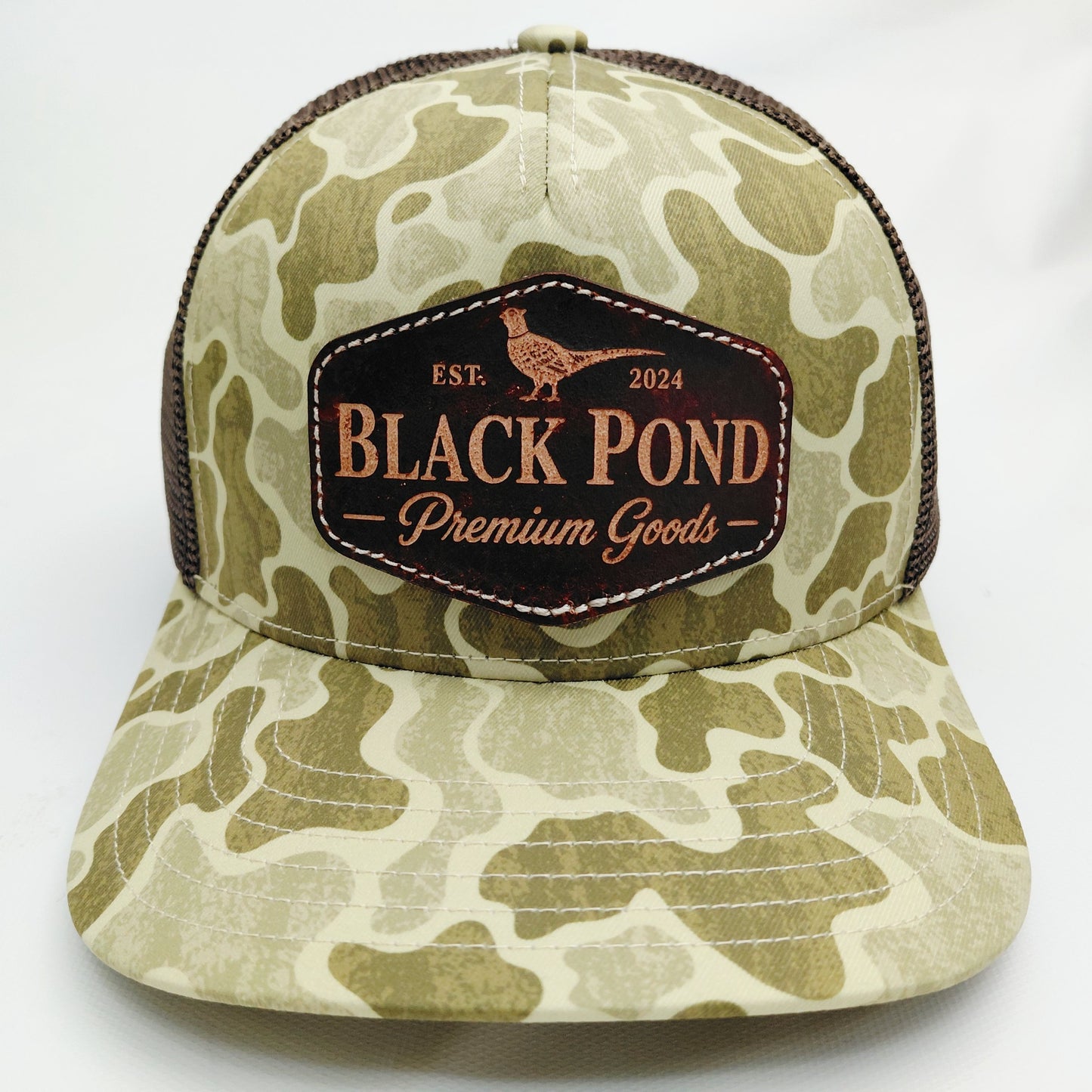 Front view of Black Pond pheasant leather patch Richardson 112 hat in tan camouflage and brown mesh