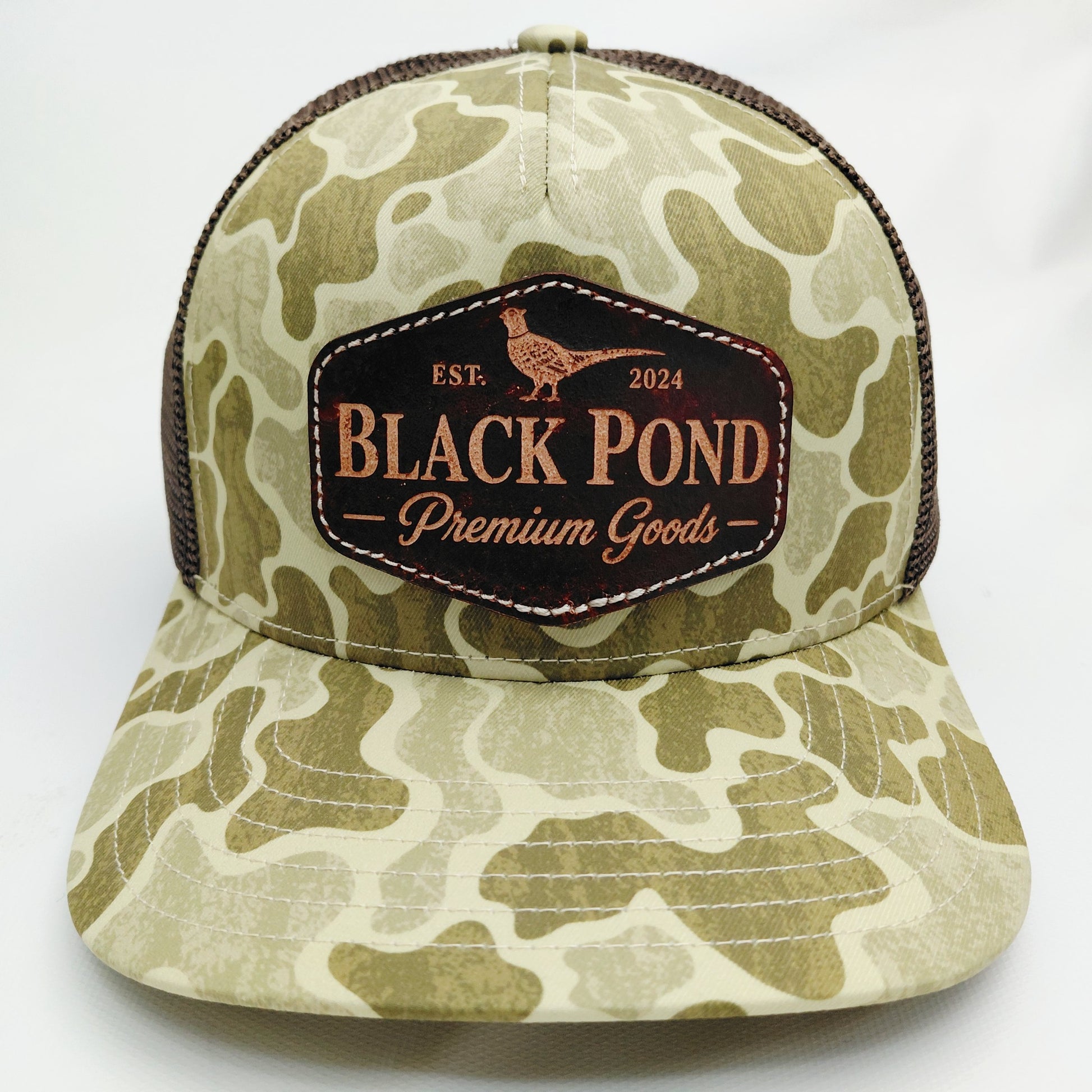 Front view of Black Pond pheasant leather patch Richardson 112 hat in tan camouflage and brown mesh