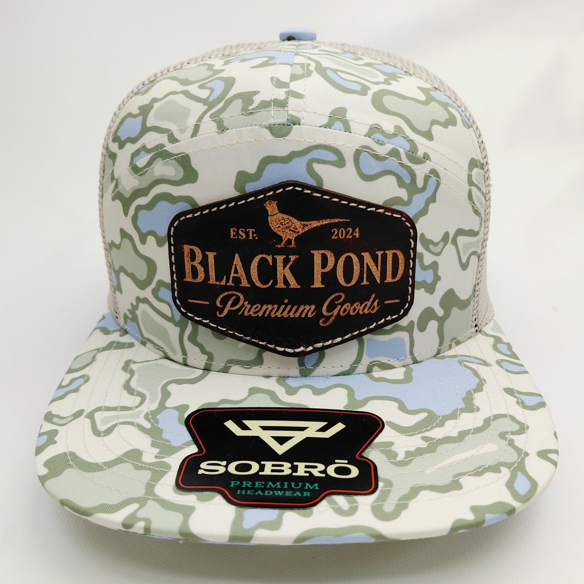 Front view of Black Pond pheasant leather patch SOBRO seven-panel hat in light green blue camouflage