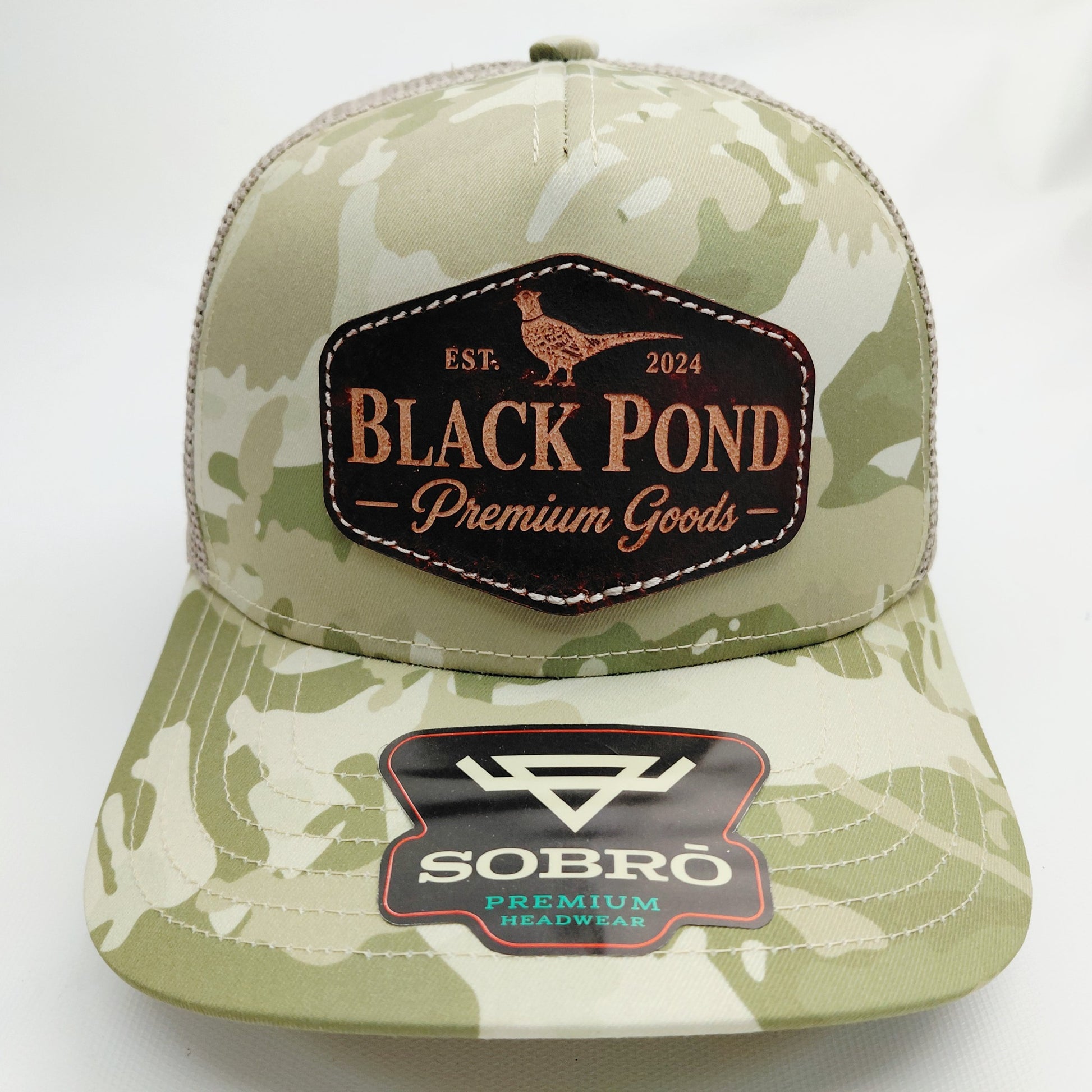 Front view of Black Pond pheasant leather patch SOBRO seven-panel hat in tan camouflage