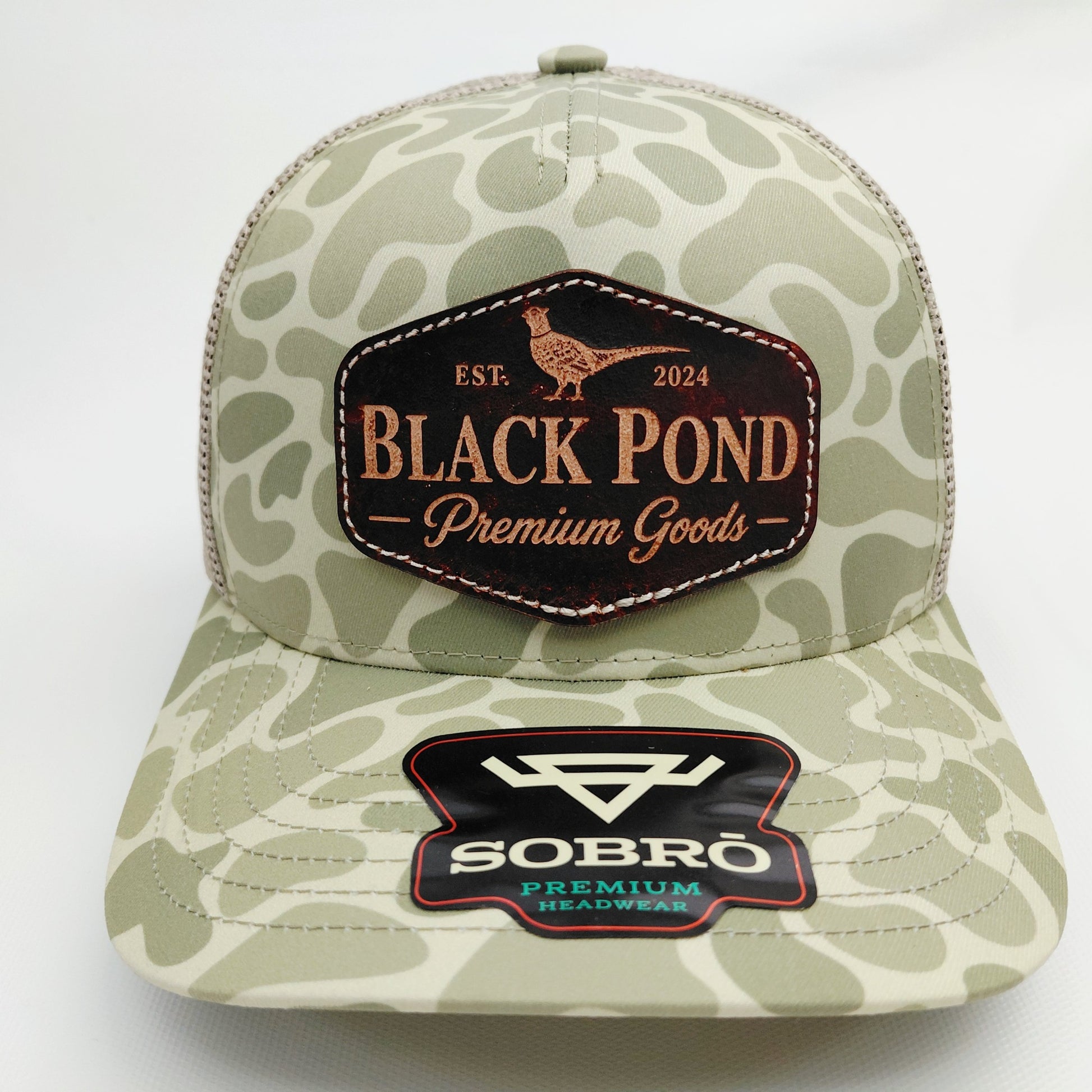 Black Pond pheasant leather patch SOBRO olive camo trucker hat front view