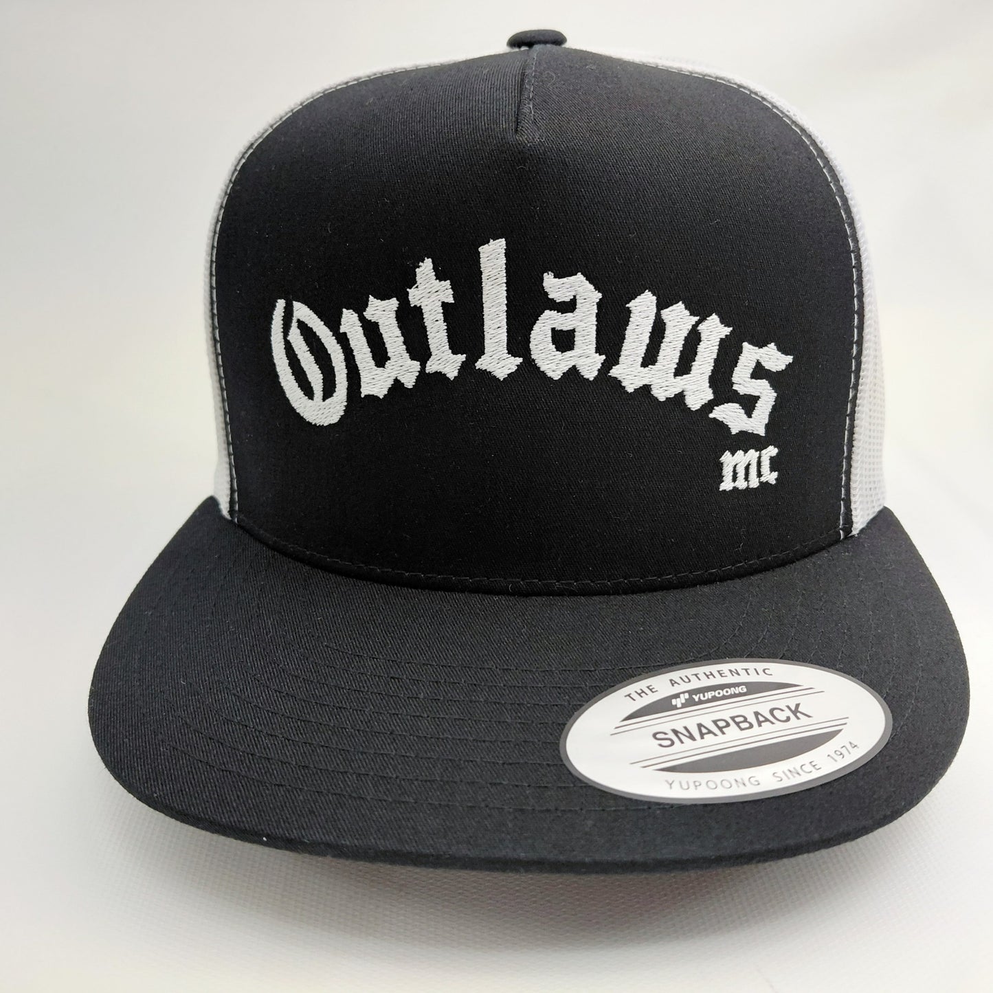 Outlaws MC black and white embroidered snapback trucker hat front view